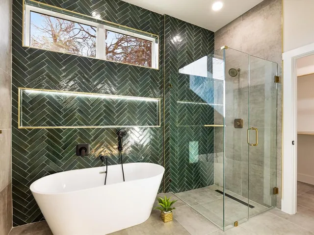 a bathroom with a bathtub and shower