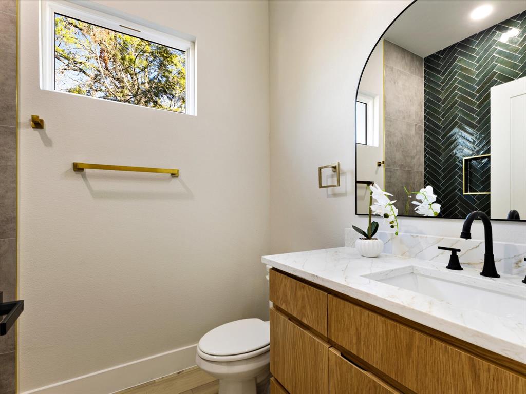 6147 Inca Drive Mabank, TX 75156 - Photo 19 of 38 a bathroom with a sink mirror vanity and toilet