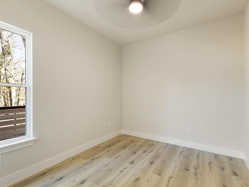 6147 Inca Drive Mabank, TX 75156 - Photo 20 of 38 an empty room with wooden floor and windows