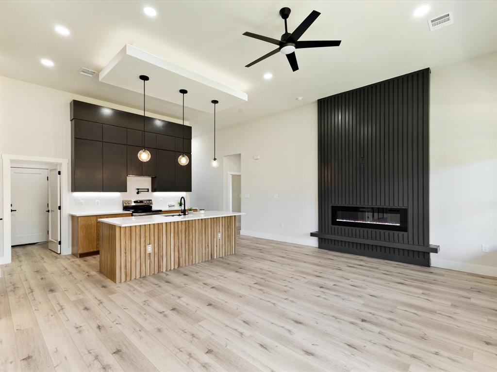 6147 Inca Drive Mabank, TX 75156 - Photo 38 of 38 a kitchen with stainless steel appliances kitchen island granite countertop a sink a stove and a wooden floors