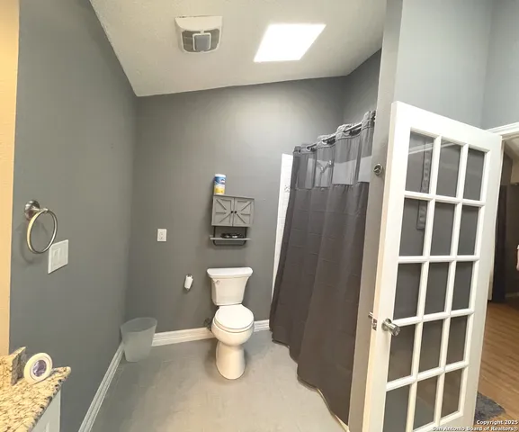 a bathroom with a toilet and a shower