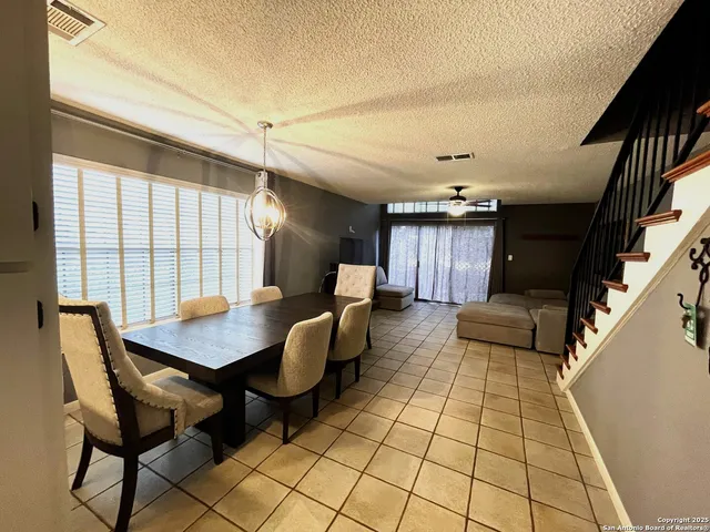 a dining room with furniture and window
