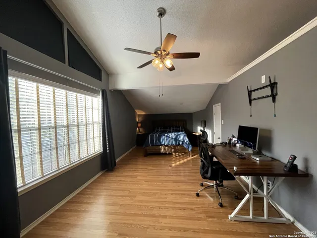 a view of a workspace with furniture and a window