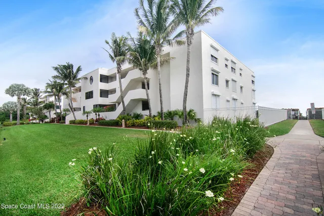 a view of a garden with a building