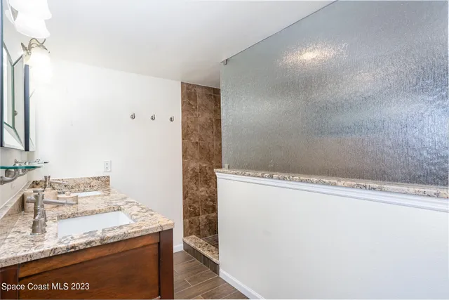 a living room with furniture a clock and a flat screen tv