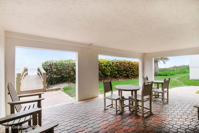 a view of a balcony with wooden floor and fence