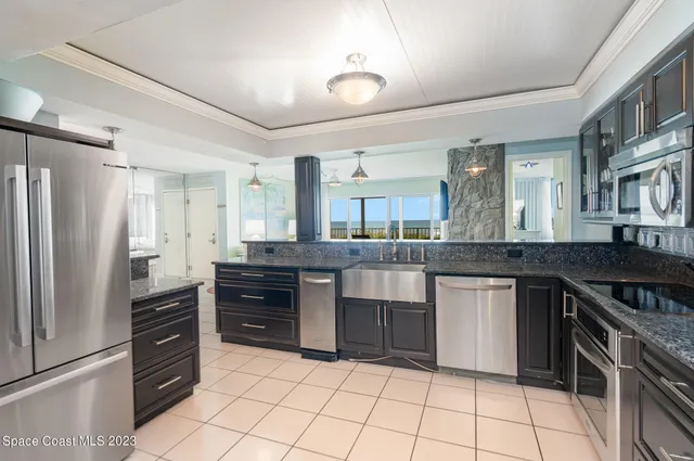 a kitchen with stainless steel appliances granite countertop a stove and a sink