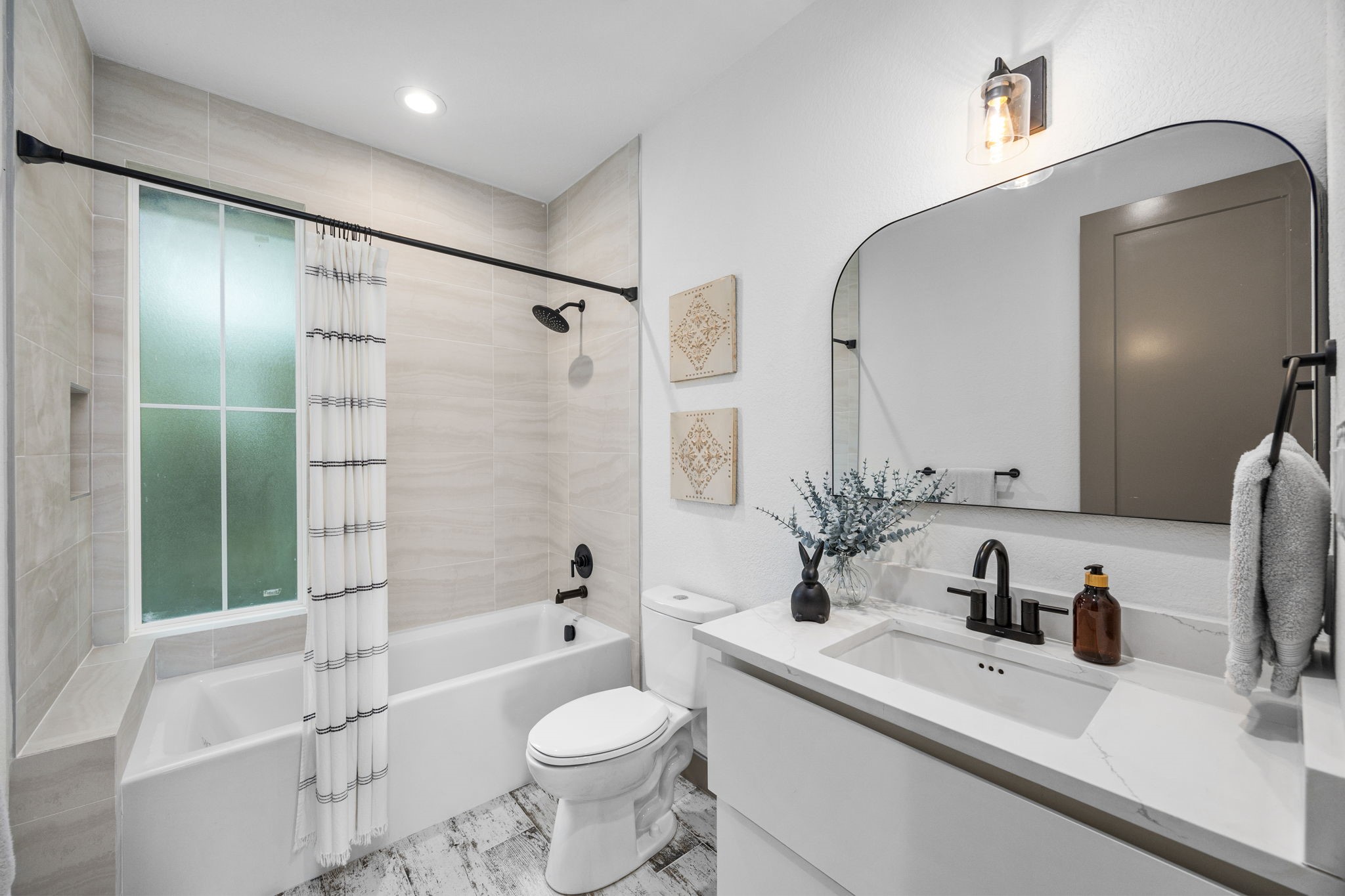 7934 Hennessy Lane, Unit 1 Spring, TX 77389 - Photo 30 of 36 a bathroom with a sink toilet tub and shower