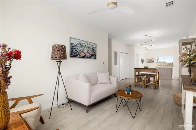 a living room with furniture and a kitchen view