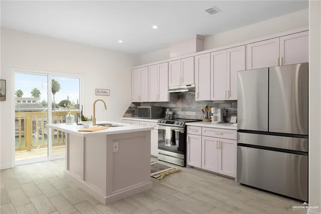 a kitchen with a refrigerator stove and sink