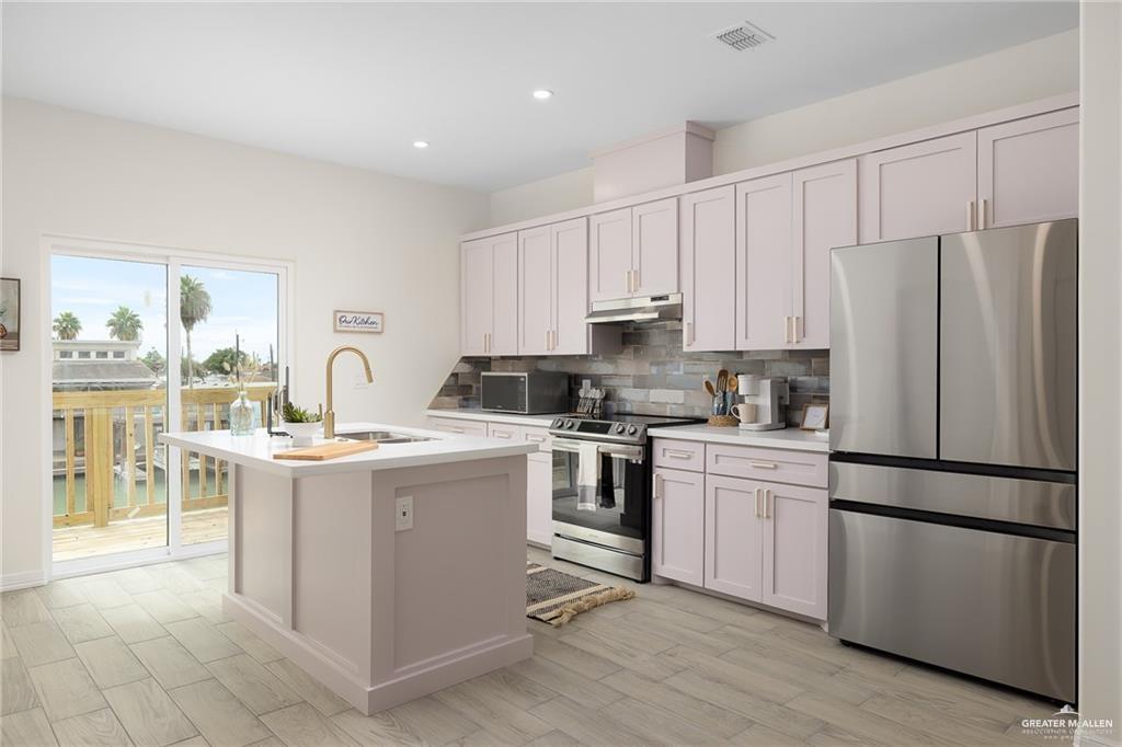 1009 Bass Avenue, Unit 3 Port Isabel, TX 78578 - Photo 4 of 14 a kitchen with a refrigerator stove and sink