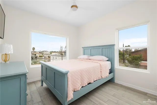 a bedroom with a large bed and a window