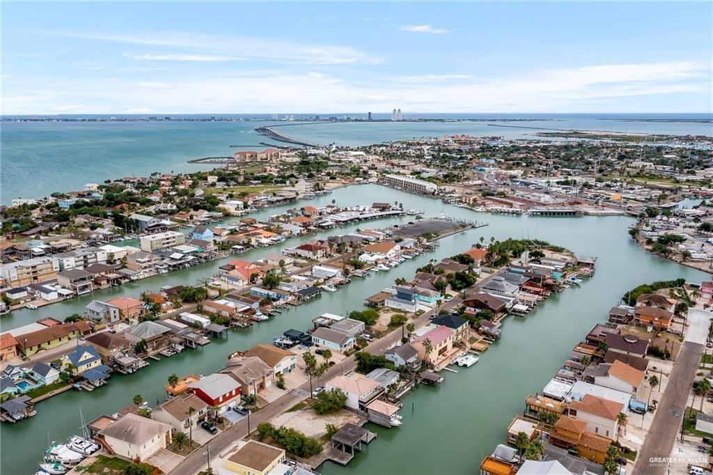 1009 Bass Avenue, Unit 3 Port Isabel, TX 78578 - Photo 10 of 14 an aerial view of a city with lots of residential buildings and ocean view in back