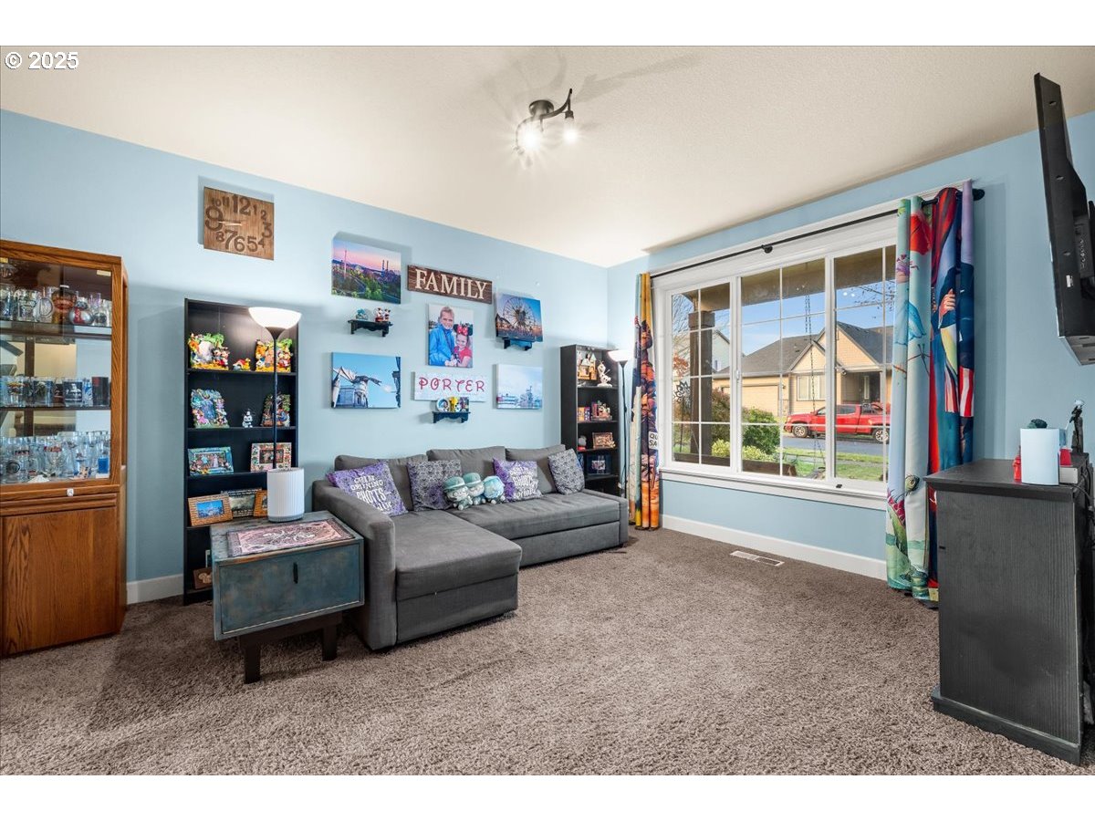 1138 37th Avenue Forest Grove, OR 97116 - Photo 11 of 48 a living room with furniture and a flat screen tv