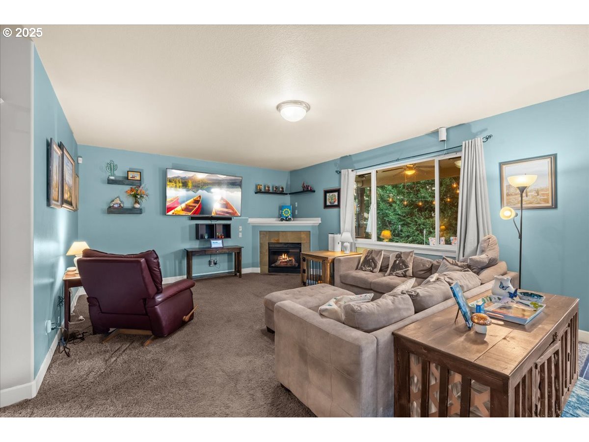 1138 37th Avenue Forest Grove, OR 97116 - Photo 24 of 48 a living room with furniture a fireplace and a large window
