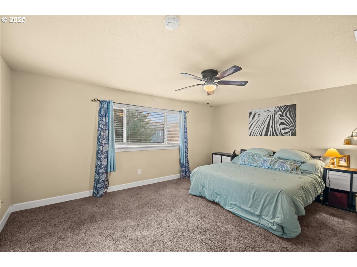 1138 37th Avenue Forest Grove, OR 97116 - Photo 27 of 48 a bedroom with a large bed and a window