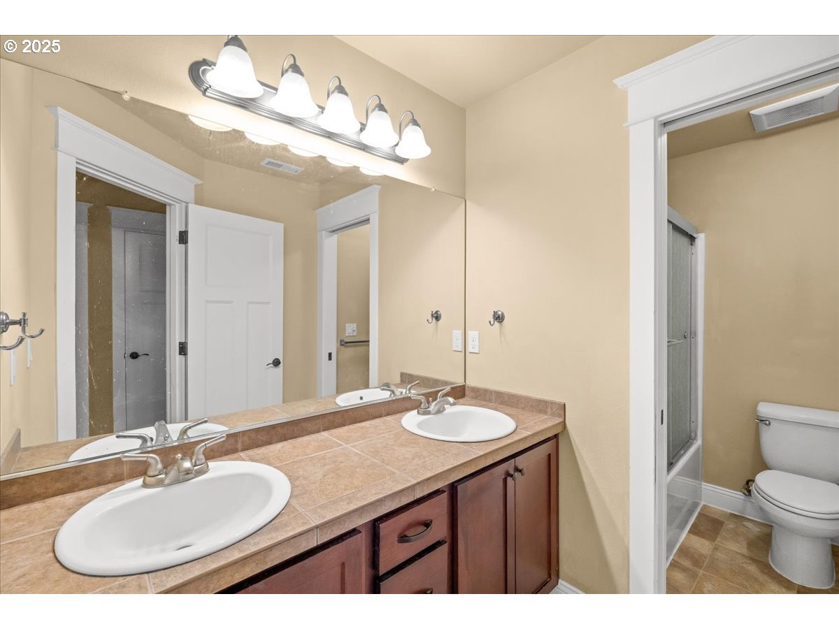 1138 37th Avenue Forest Grove, OR 97116 - Photo 37 of 48 a bathroom with a granite countertop sink a mirror and a toilet