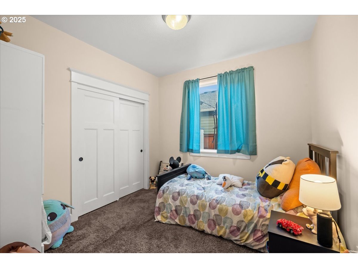 1138 37th Avenue Forest Grove, OR 97116 - Photo 39 of 48 a bedroom with a bed and teddy bear on bed