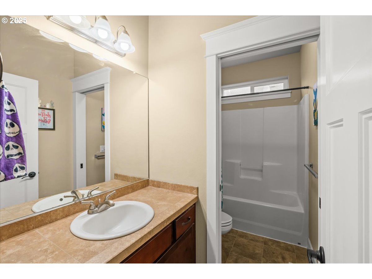 1138 37th Avenue Forest Grove, OR 97116 - Photo 40 of 48 a bathroom with a sink vanity granite tub and a mirror