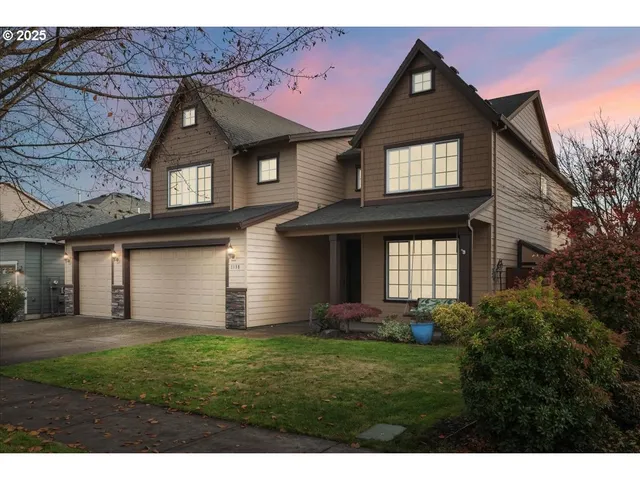 a front view of a house with a yard and garage