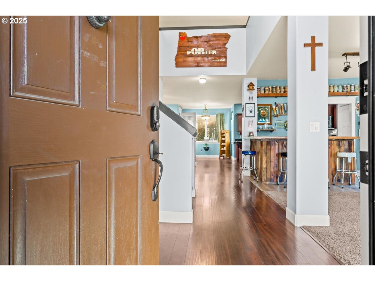 1138 37th Avenue Forest Grove, OR 97116 - Photo 8 of 48 a view of a hallway with wooden floor and dining room