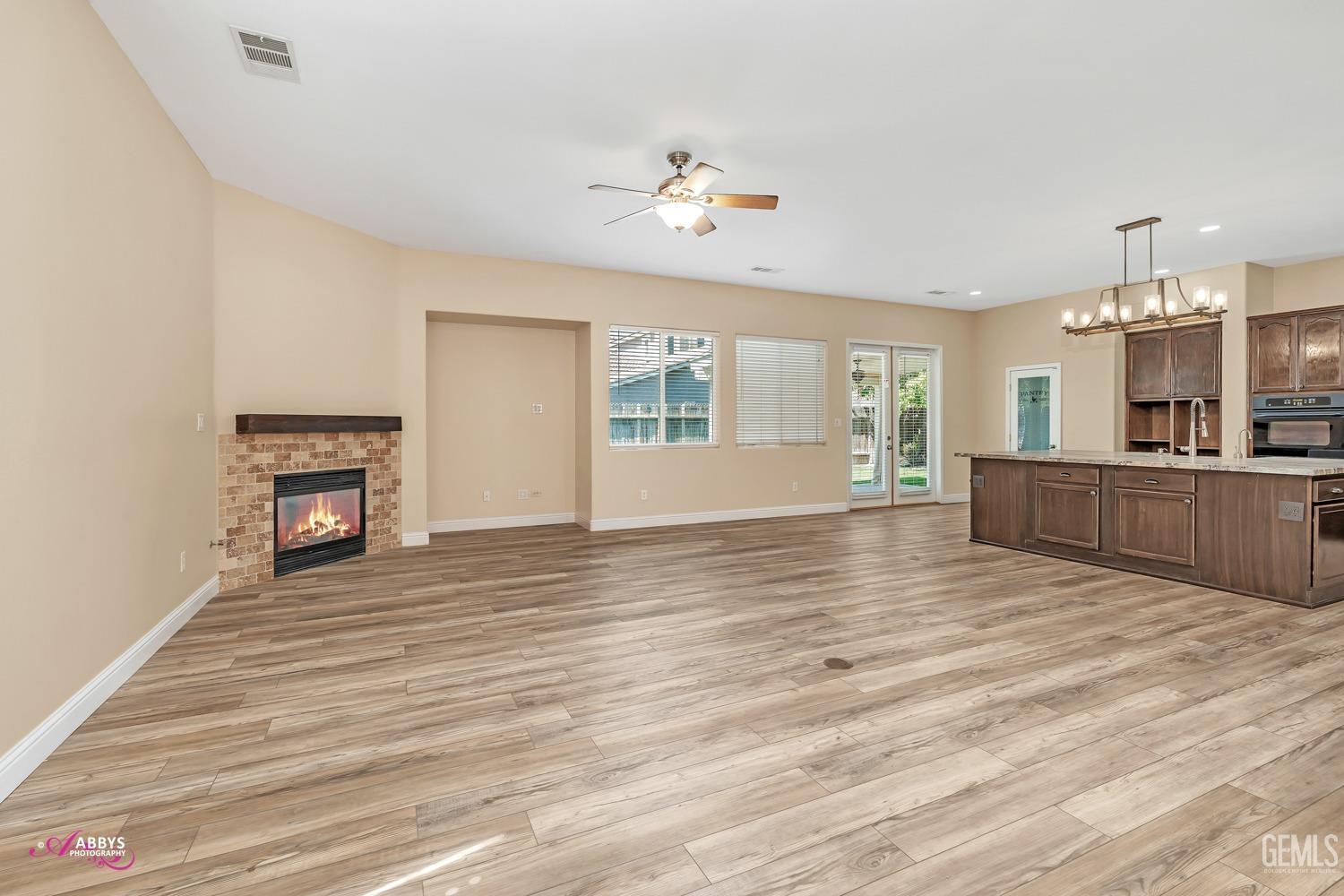 Undisclosed Address Bakersfield, CA 93311 - Photo 11 of 41 a view of a livingroom with wooden floor and a ceiling fan