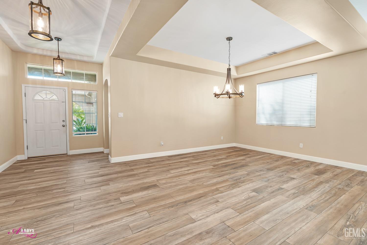 Undisclosed Address Bakersfield, CA 93311 - Photo 12 of 41 a view of empty room with wooden floor and ceiling fan
