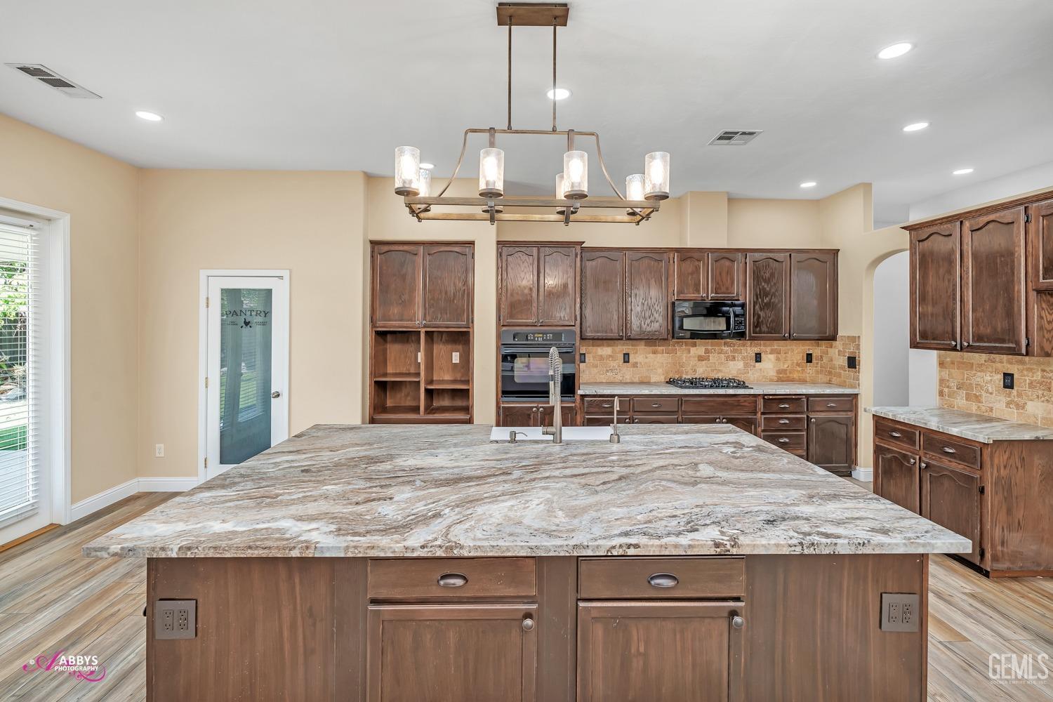 Undisclosed Address Bakersfield, CA 93311 - Photo 14 of 41 a kitchen with stainless steel appliances granite countertop wooden cabinets and a granite counter tops