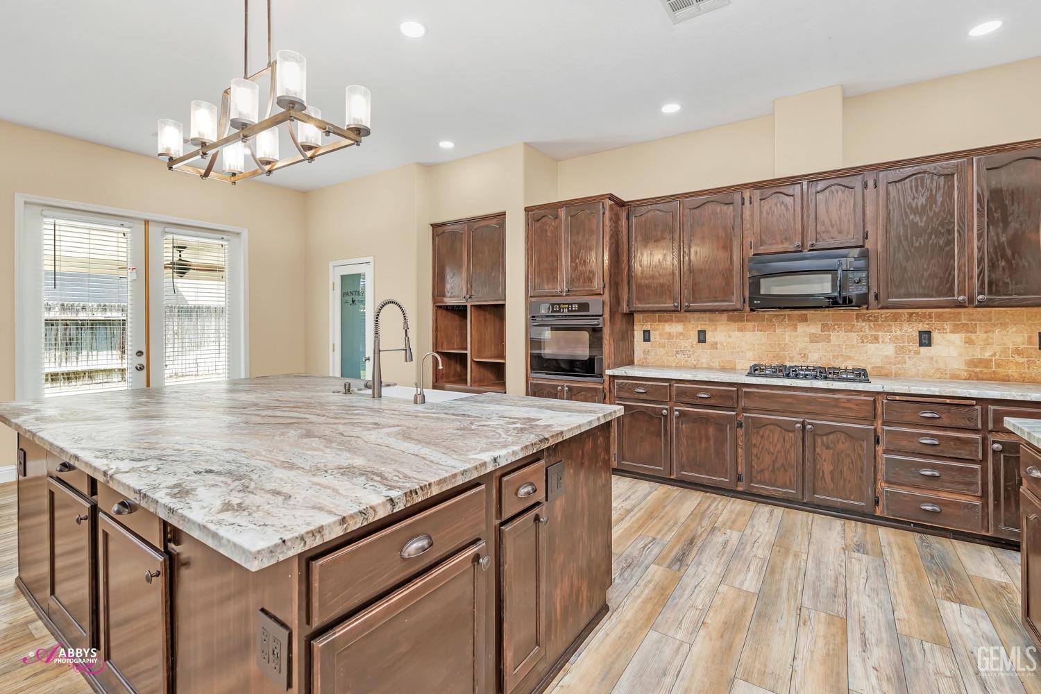 Undisclosed Address Bakersfield, CA 93311 - Photo 17 of 41 a kitchen with a sink refrigerator and cabinets