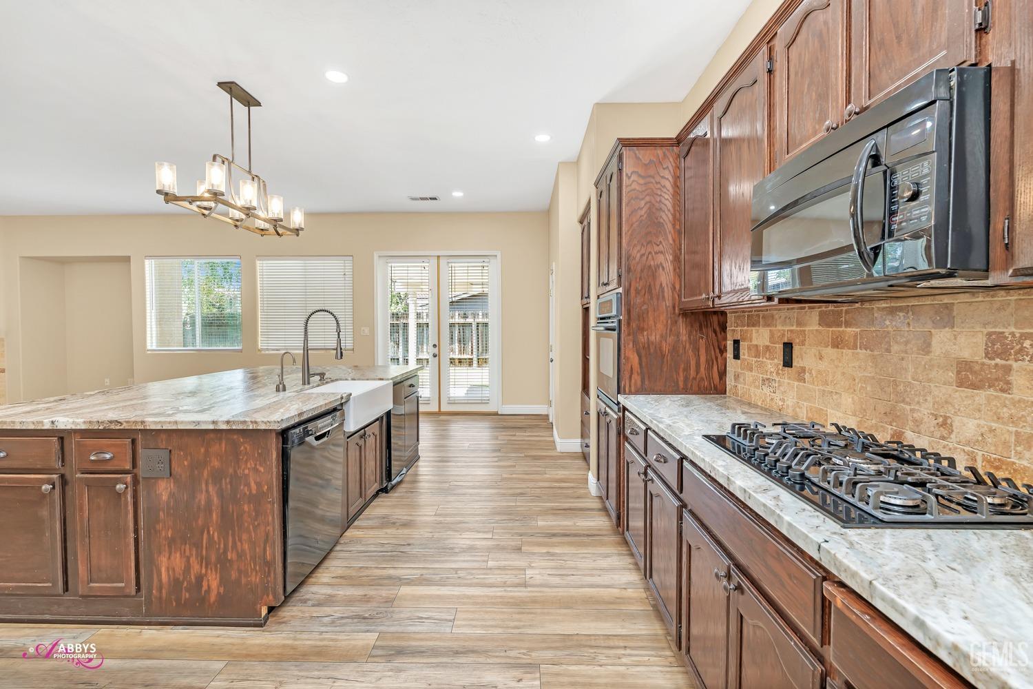 Undisclosed Address Bakersfield, CA 93311 - Photo 18 of 41 a kitchen with stainless steel appliances granite countertop a stove and a wooden cabinets