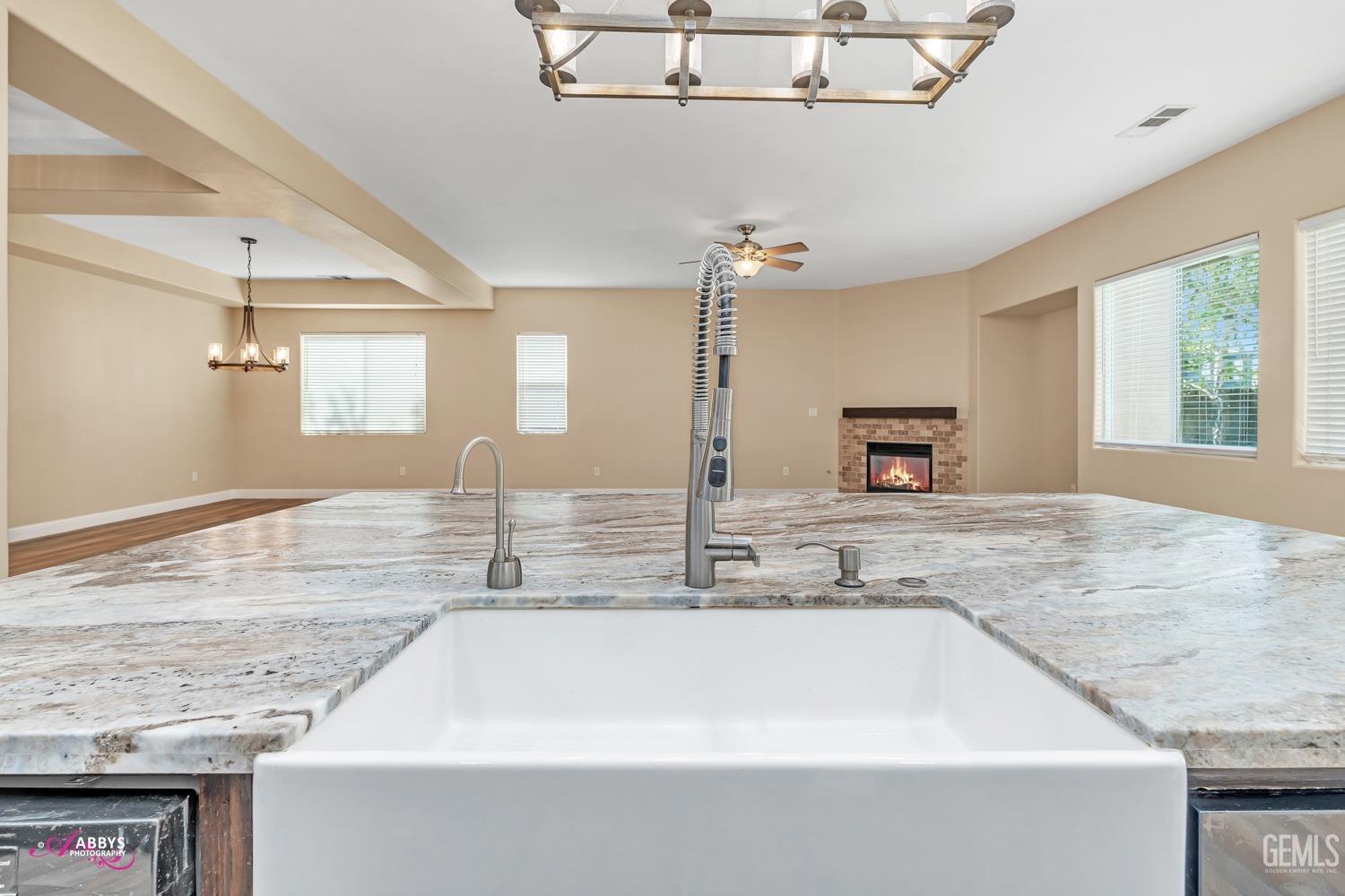Undisclosed Address Bakersfield, CA 93311 - Photo 20 of 41 a bathroom with a granite countertop sink a toilet and mirror