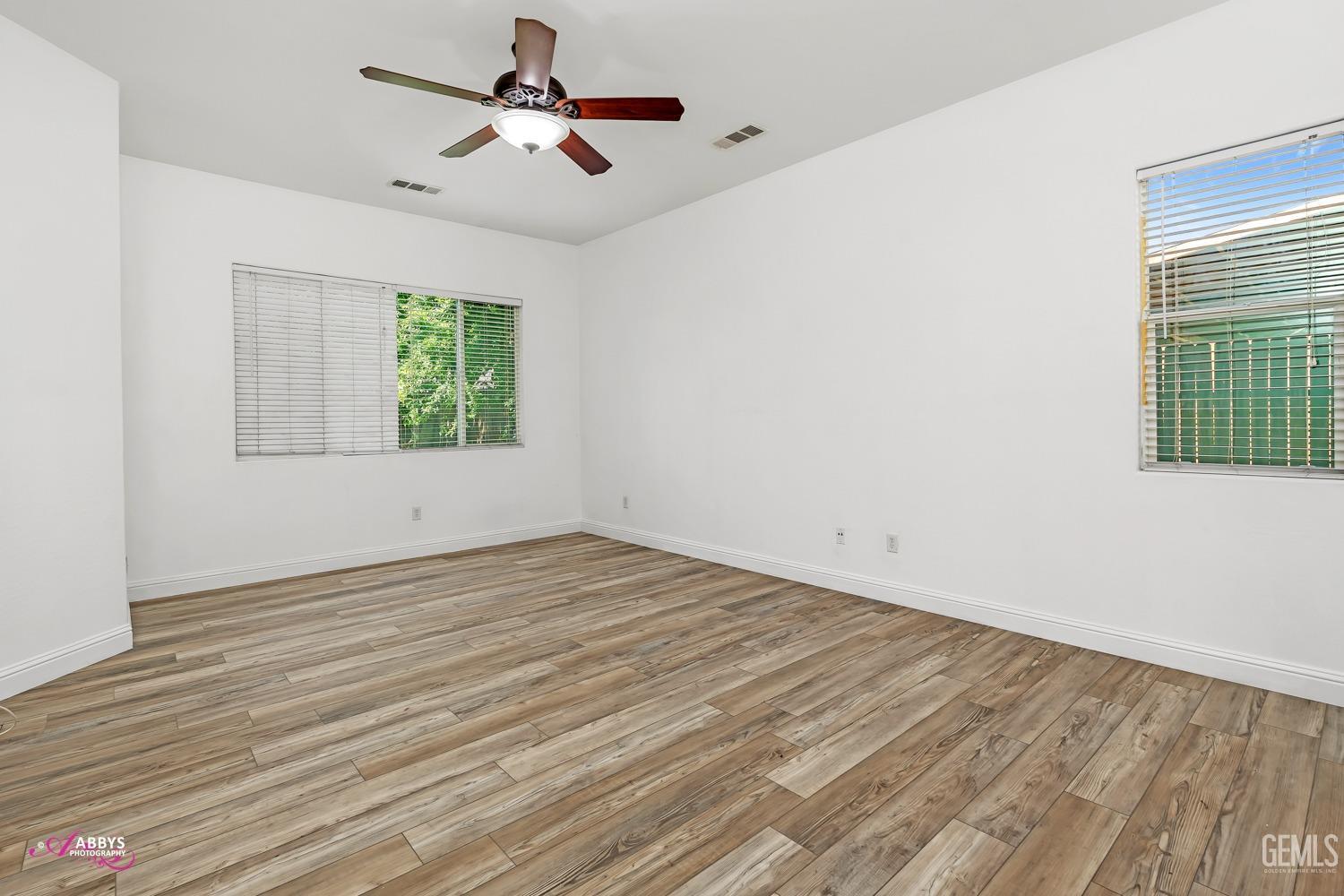 Undisclosed Address Bakersfield, CA 93311 - Photo 22 of 41 a view of empty room with wooden floor and fan
