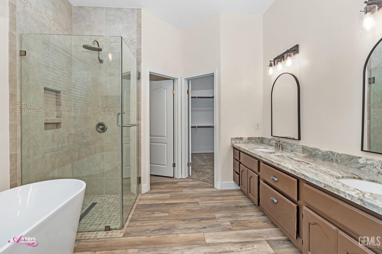 Undisclosed Address Bakersfield, CA 93311 - Photo 23 of 41 a spacious bathroom with a granite countertop sink mirror and shower