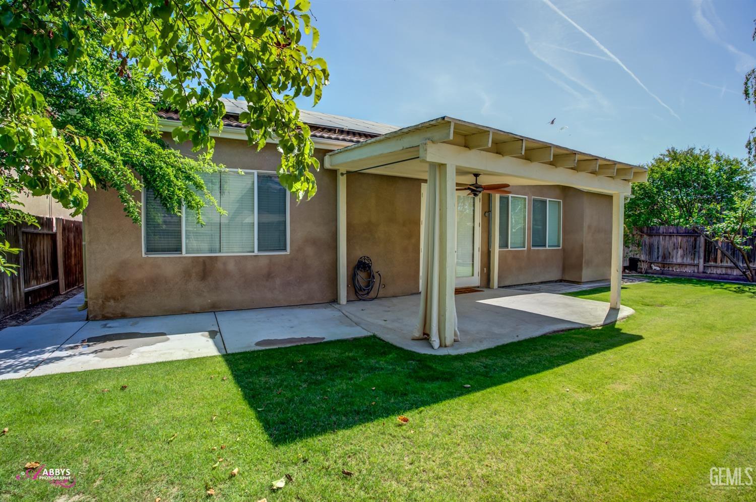 Undisclosed Address Bakersfield, CA 93311 - Photo 34 of 41 a front view of a house with a yard and trees