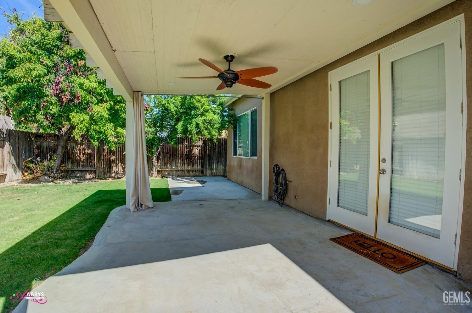 Undisclosed Address Bakersfield, CA 93311 - Photo 39 of 41 a view of a porch with couches and table and chairs under an umbrella