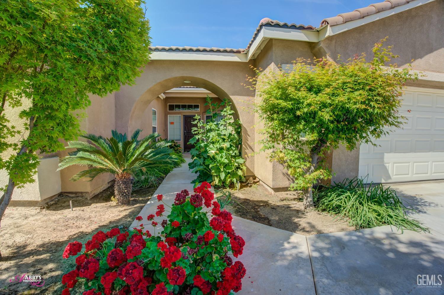 Undisclosed Address Bakersfield, CA 93311 - Photo 7 of 41 a front view of house with flower around