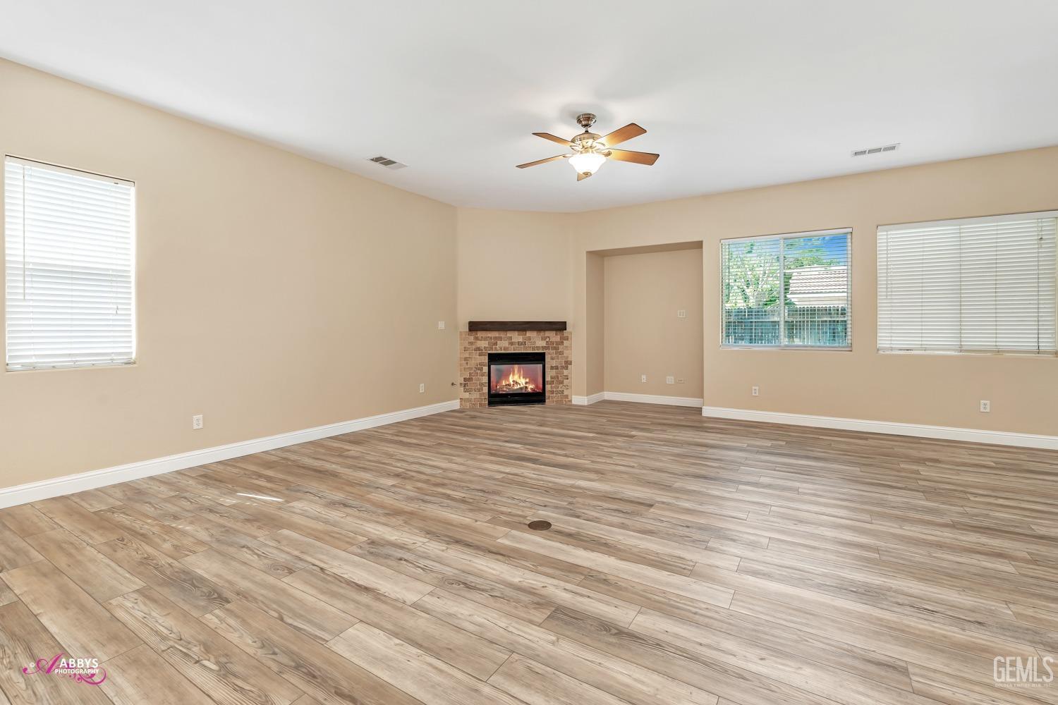 Undisclosed Address Bakersfield, CA 93311 - Photo 10 of 41 a view of an empty room with a window and wooden floor
