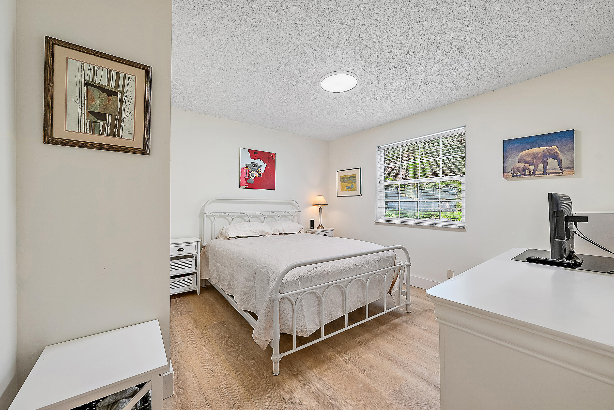 15629 95th Avenue North Jupiter, FL 33478 - Photo 13 of 25 a bedroom with a bed and a desk