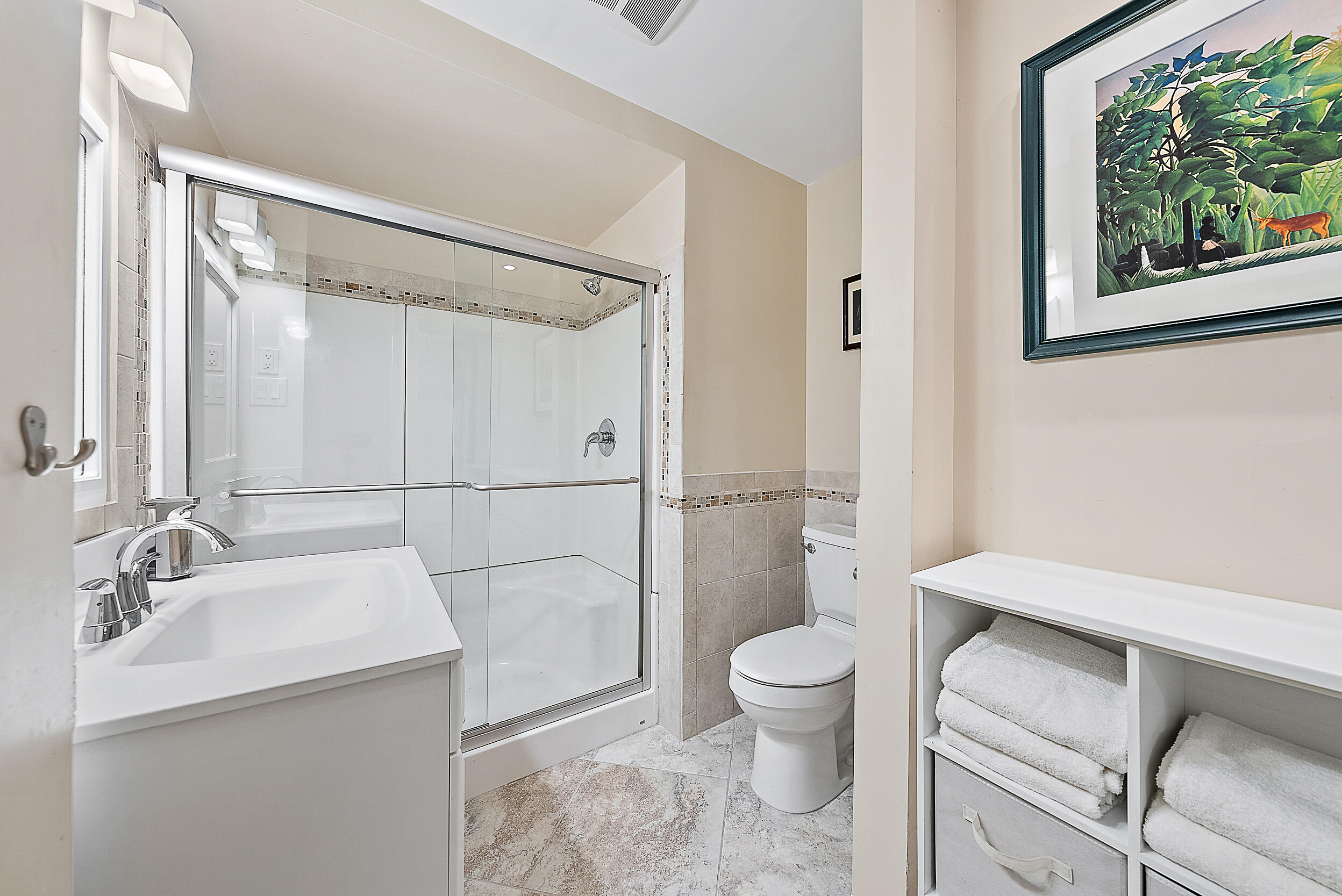 15629 95th Avenue North Jupiter, FL 33478 - Photo 14 of 25 a bathroom with a sink a toilet a shower and a mirror