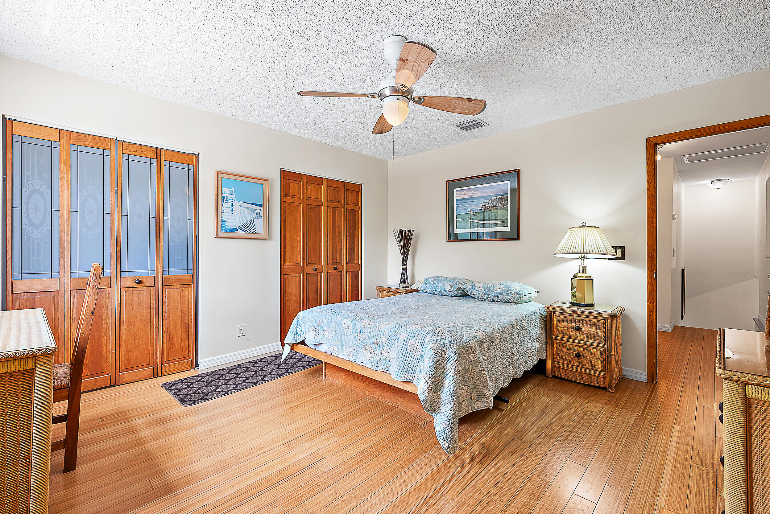 15629 95th Avenue North Jupiter, FL 33478 - Photo 15 of 25 a bedroom with a bed and wooden floor