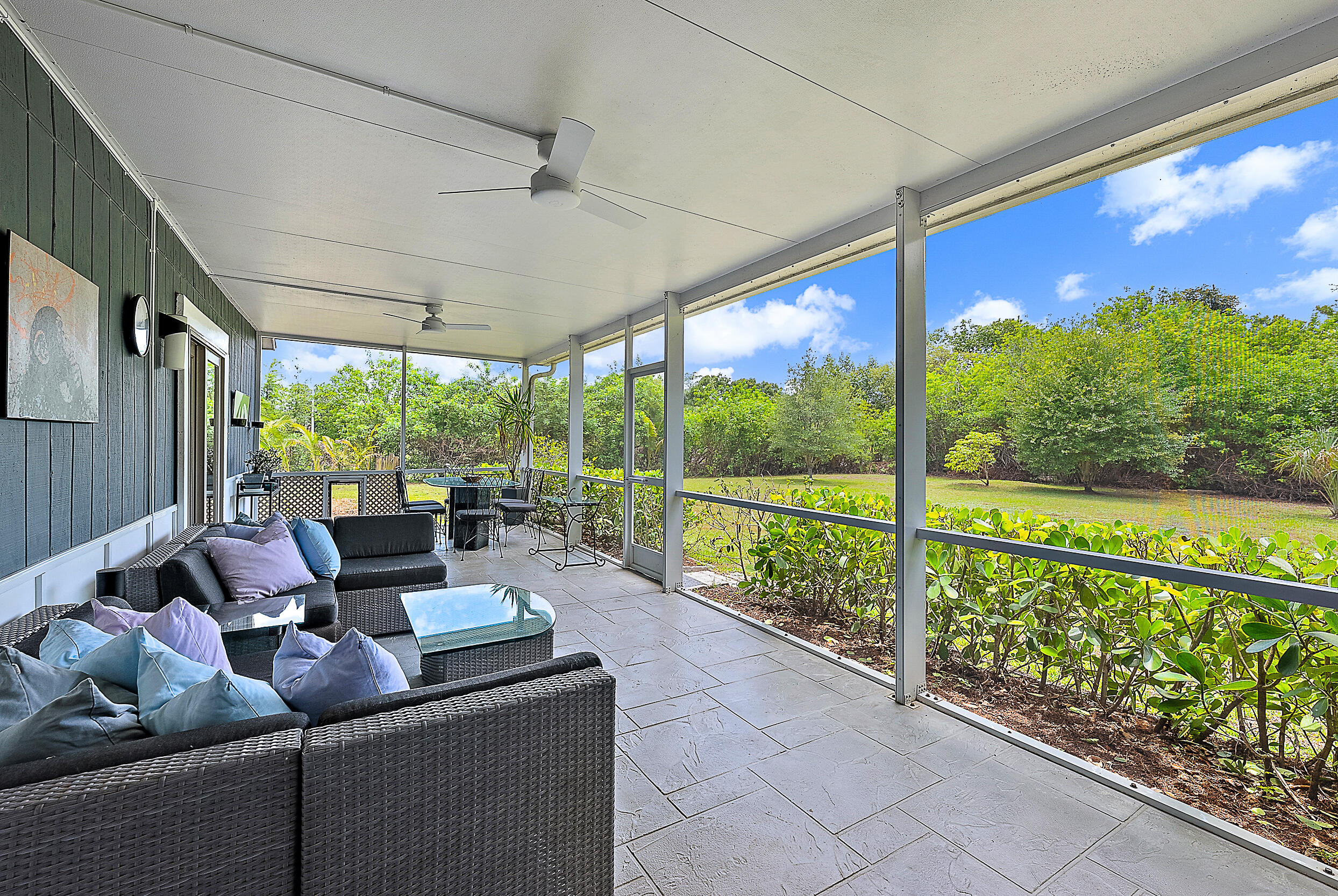 15629 95th Avenue North Jupiter, FL 33478 - Photo 19 of 25 a living room with furniture and a floor to ceiling window
