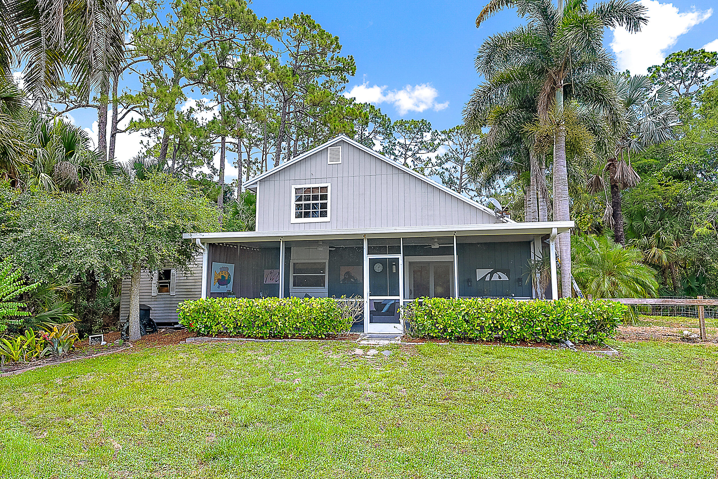 15629 95th Avenue North Jupiter, FL 33478 - Photo 20 of 25 a front view of a house with a garden