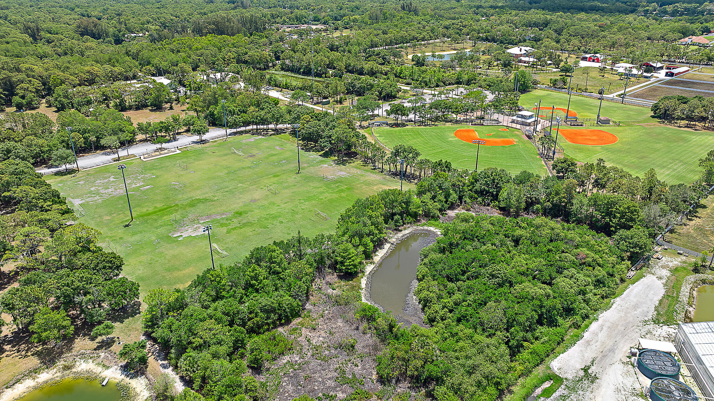 15629 95th Avenue North Jupiter, FL 33478 - Photo 24 of 25 an aerial view of residential houses with outdoor space and swimming pool