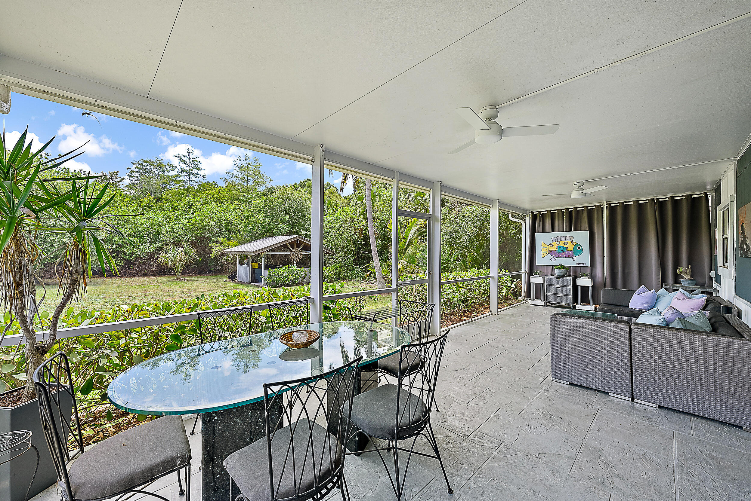 15629 95th Avenue North Jupiter, FL 33478 - Photo 4 of 25 a living room with furniture and a floor to ceiling window