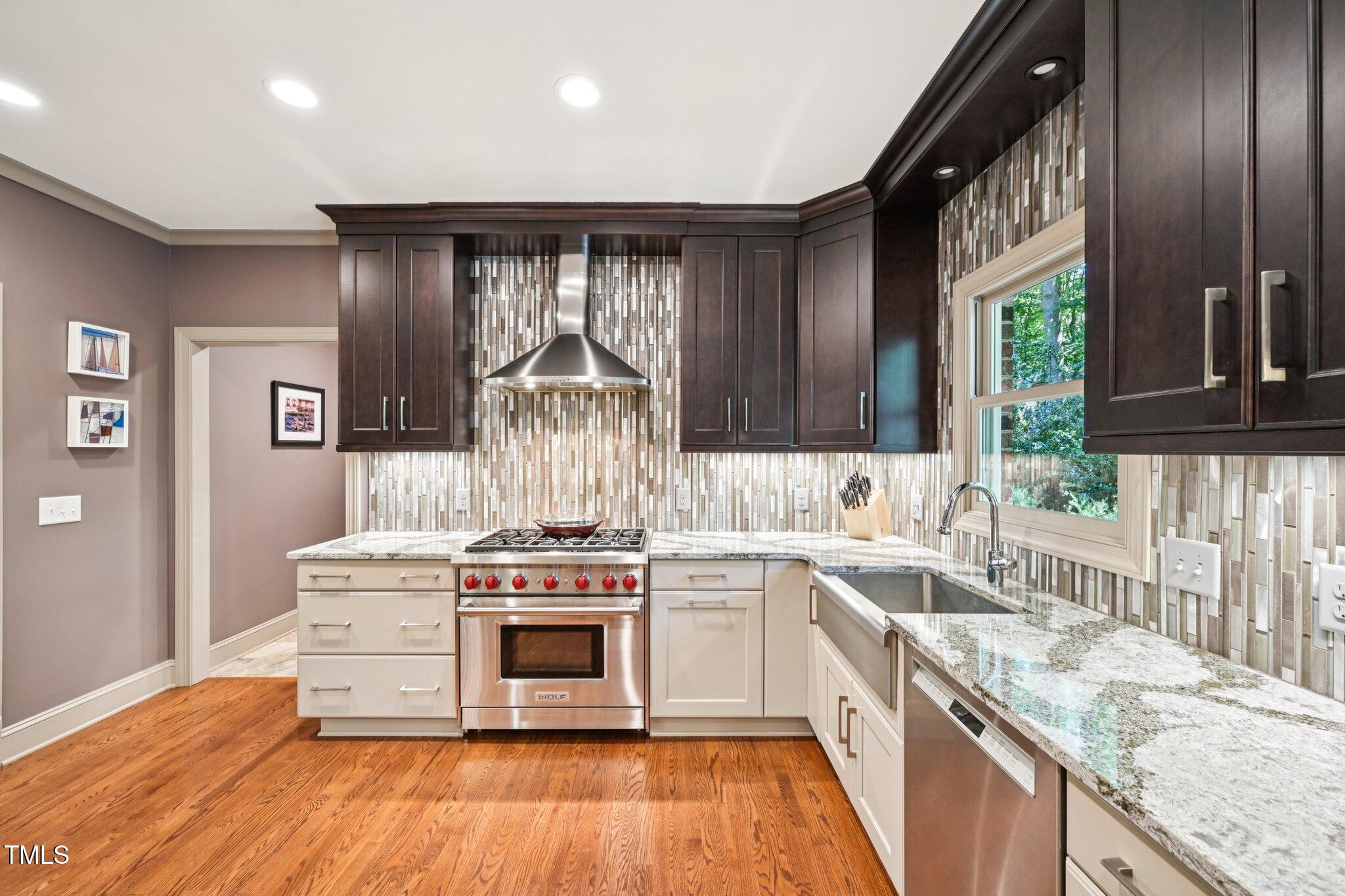 3413 1st Place Raleigh, NC 27613 - Photo 11 of 43 a kitchen with a stove top oven sink and cabinets