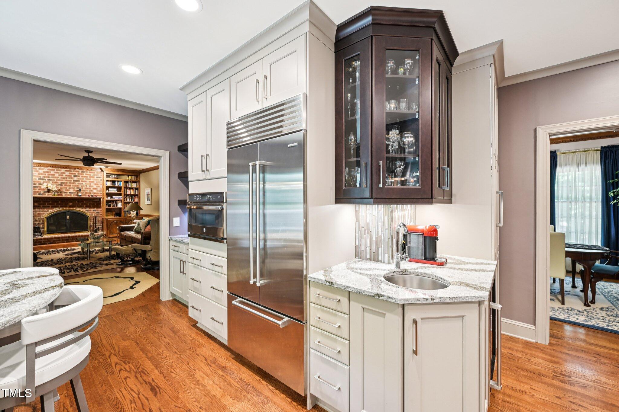 3413 1st Place Raleigh, NC 27613 - Photo 12 of 43 a kitchen with granite countertop a refrigerator and a stove top oven