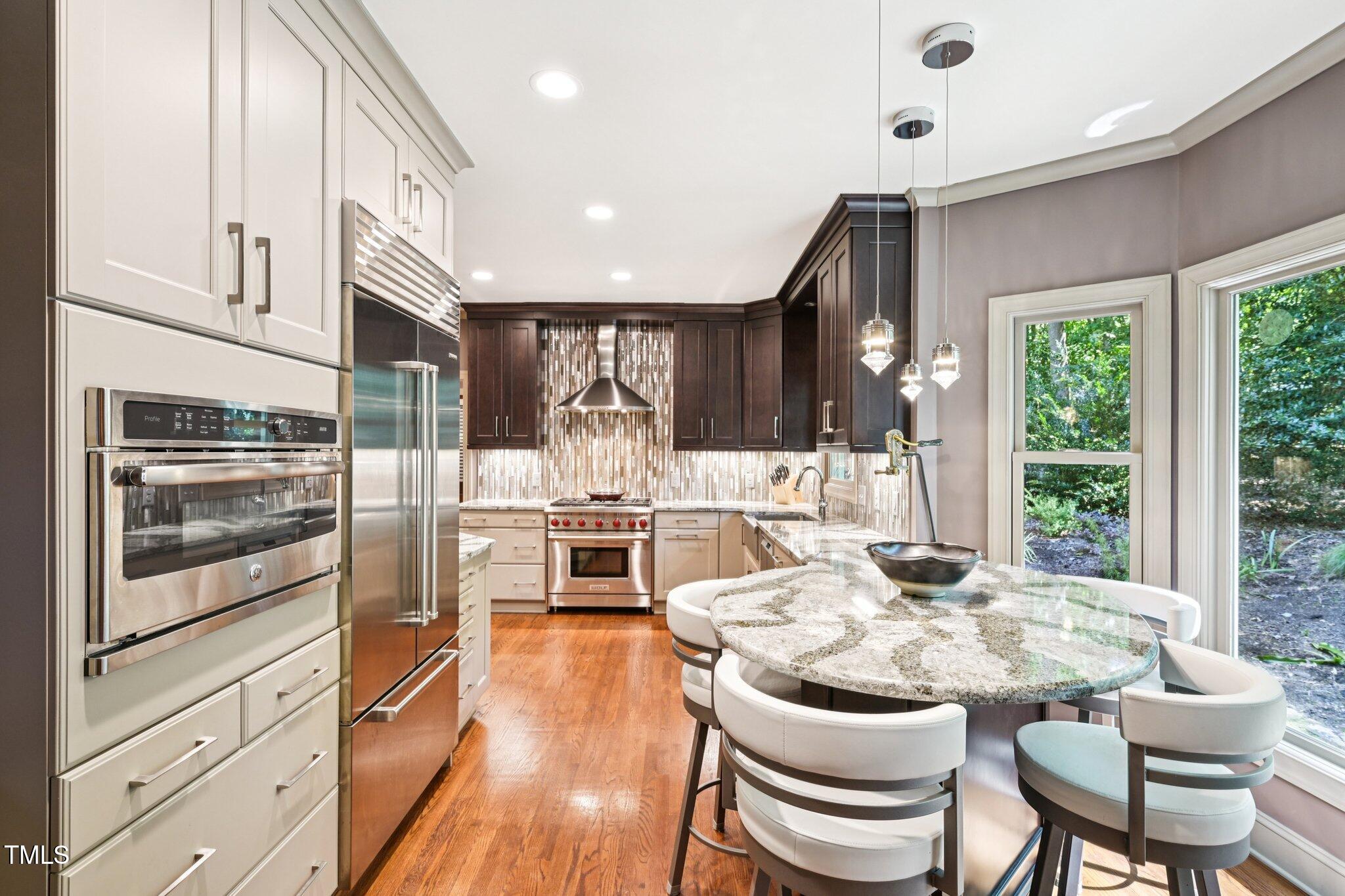 3413 1st Place Raleigh, NC 27613 - Photo 13 of 43 a kitchen with a sink and chairs