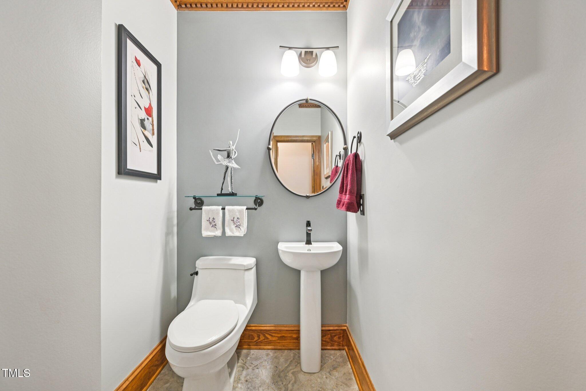 3413 1st Place Raleigh, NC 27613 - Photo 19 of 43 a bathroom with a toilet and a sink