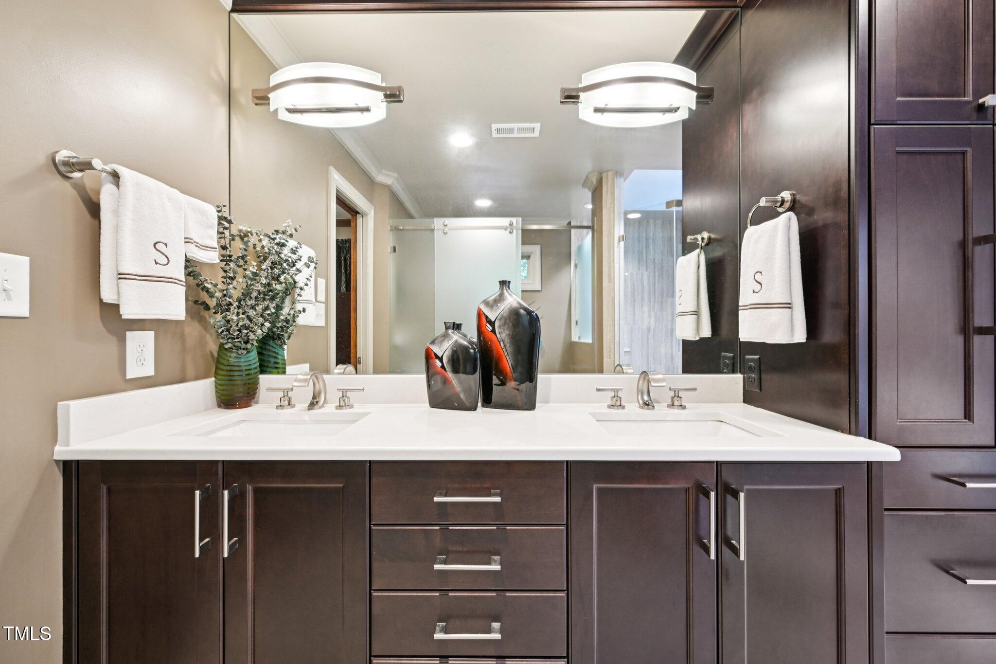 3413 1st Place Raleigh, NC 27613 - Photo 28 of 43 a bathroom with a granite countertop sink a large mirror and vanity