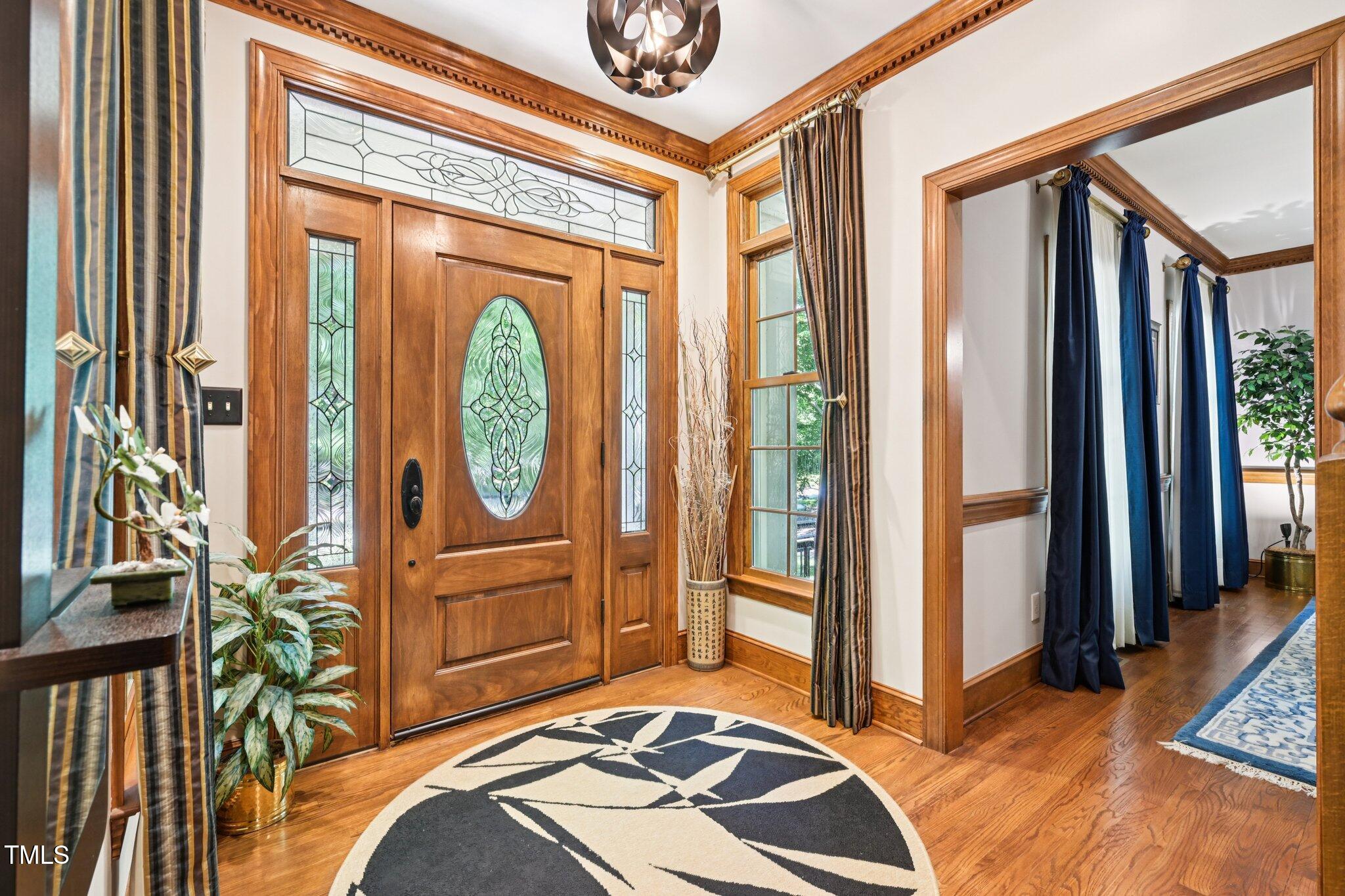 3413 1st Place Raleigh, NC 27613 - Photo 3 of 43 a bedroom with a bed a mirror and a large window